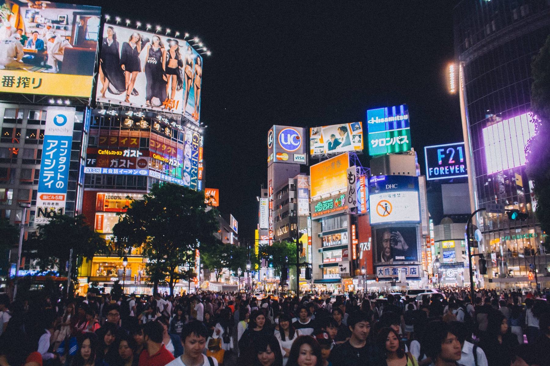 Shibuya crossing at night in Tokyo lit by neon signs